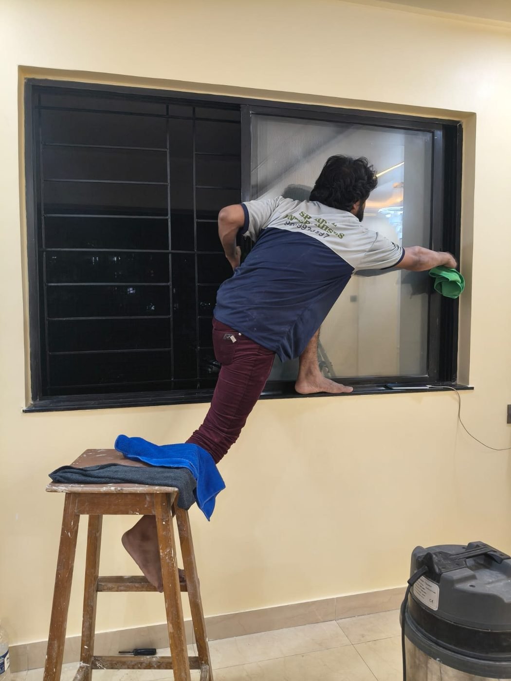 Staff member cleaning a window